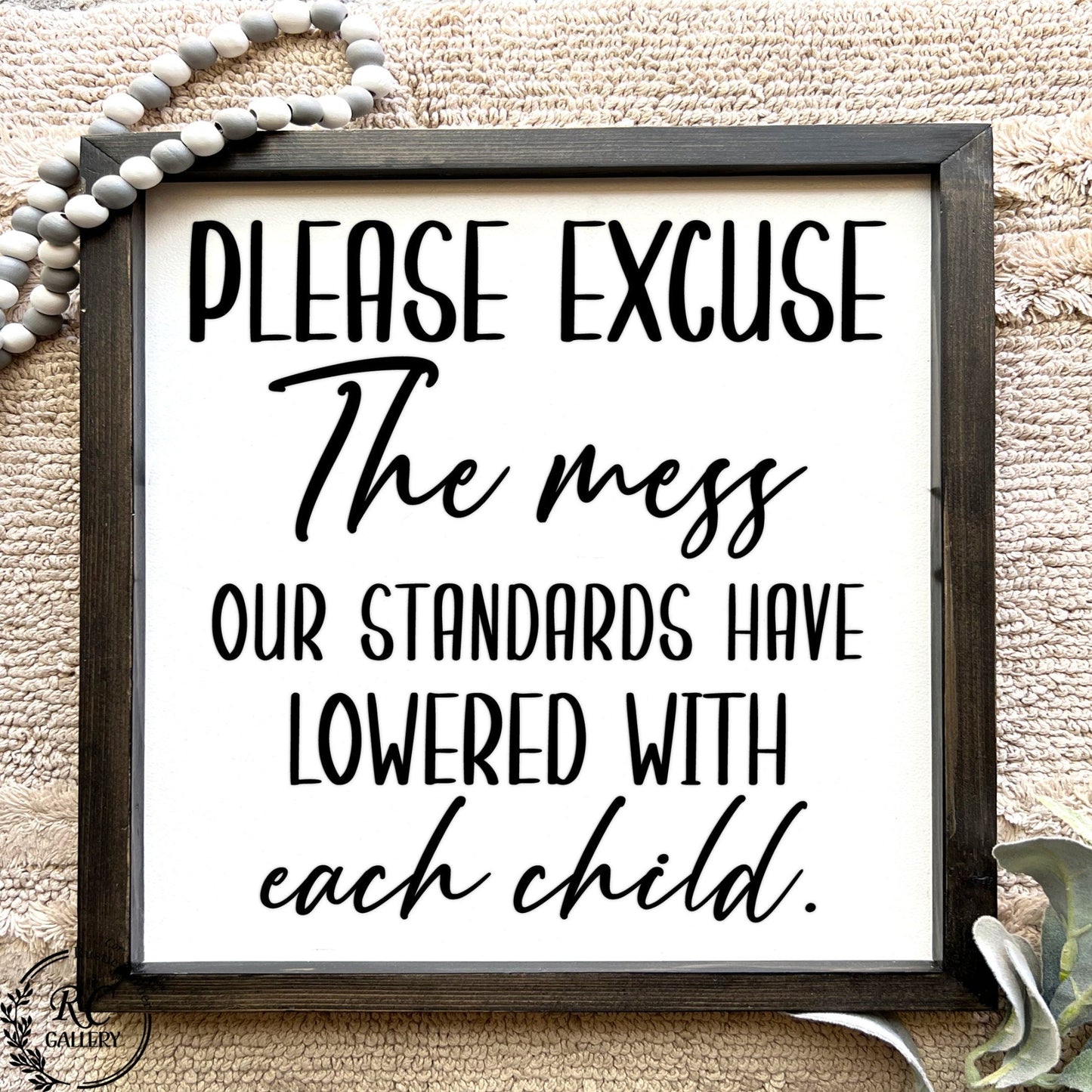 Please Excuse the mess, our standard have lowered with each child, living room wood sign.