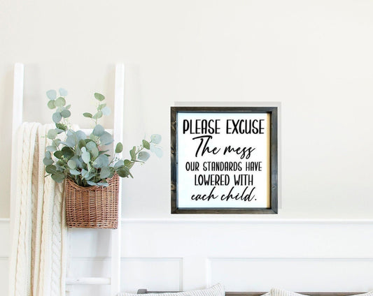 Please Excuse the mess, our standard have lowered with each child, living room wood sign.